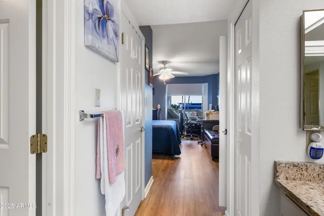 a view of a hallway with livingroom and furniture