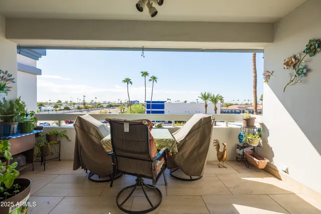 a dining room with furniture and a floor to ceiling window