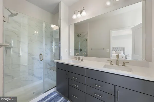 a bathroom with double sink and a mirror