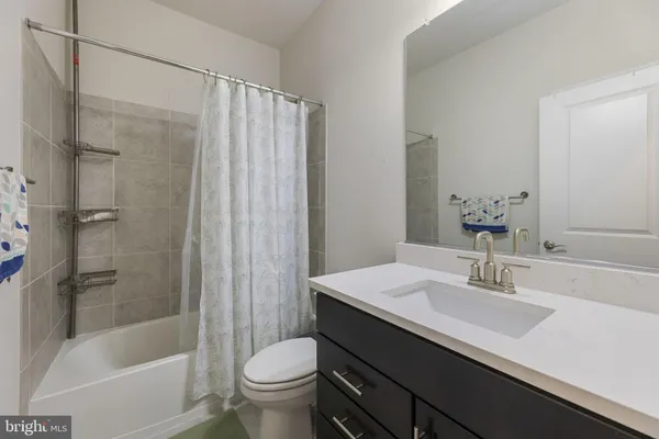 a bathroom with a sink a toilet and a bathtub