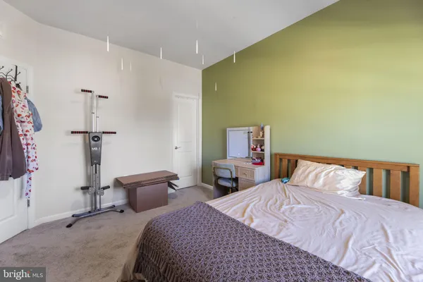 a bedroom with a bed and a table