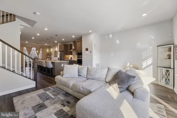 a living room with furniture and a kitchen view