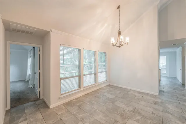 a view of a chandelier in big room and chandelier