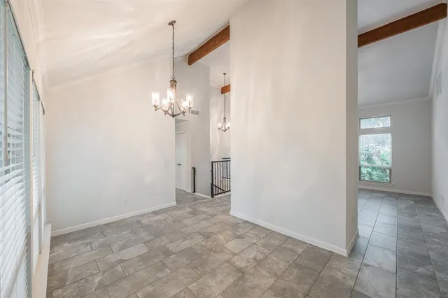 a large kitchen with cabinets stainless steel appliances and a window
