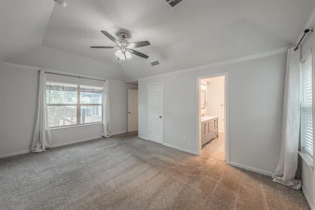 a spacious bathroom with a granite countertop sink a toilet and shower