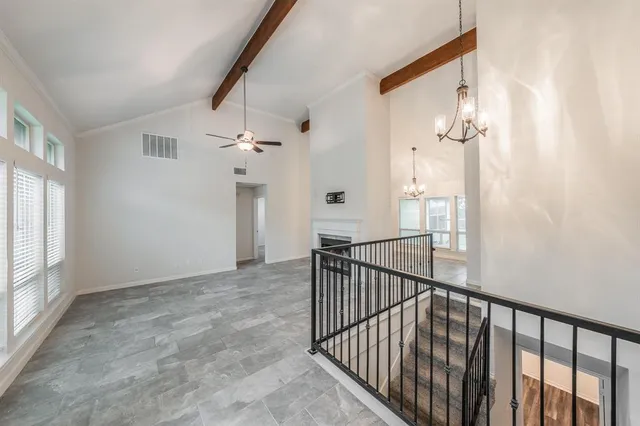 a view of a livingroom with a ceiling fan and window