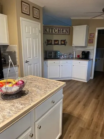 a large kitchen with stainless steel appliances granite countertop a stove a sink dishwasher and a refrigerator