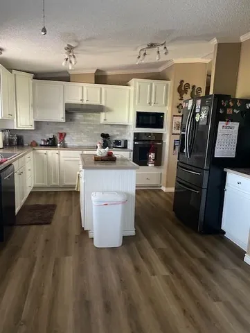 a kitchen with granite countertop a sink and cabinets
