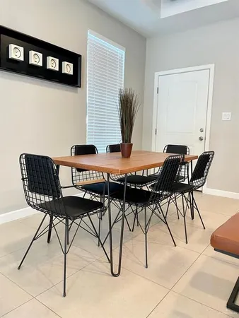 a view of a dining room with furniture and rug