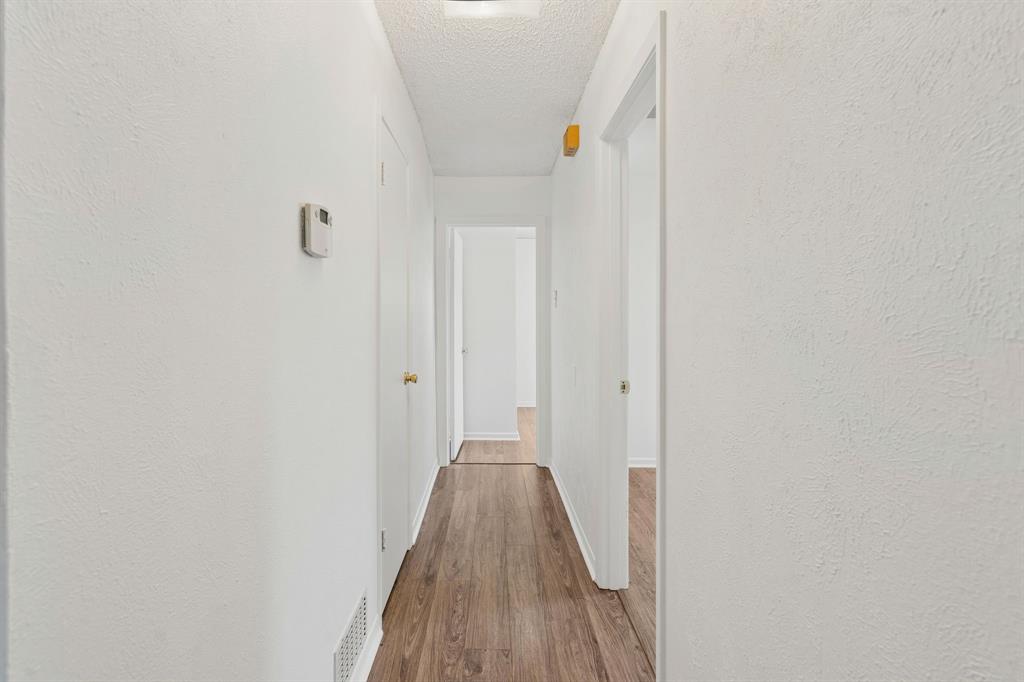 1822 Finley Road Irving, TX 75062 - Photo 21 of 38 a view of a hallway with wooden floor