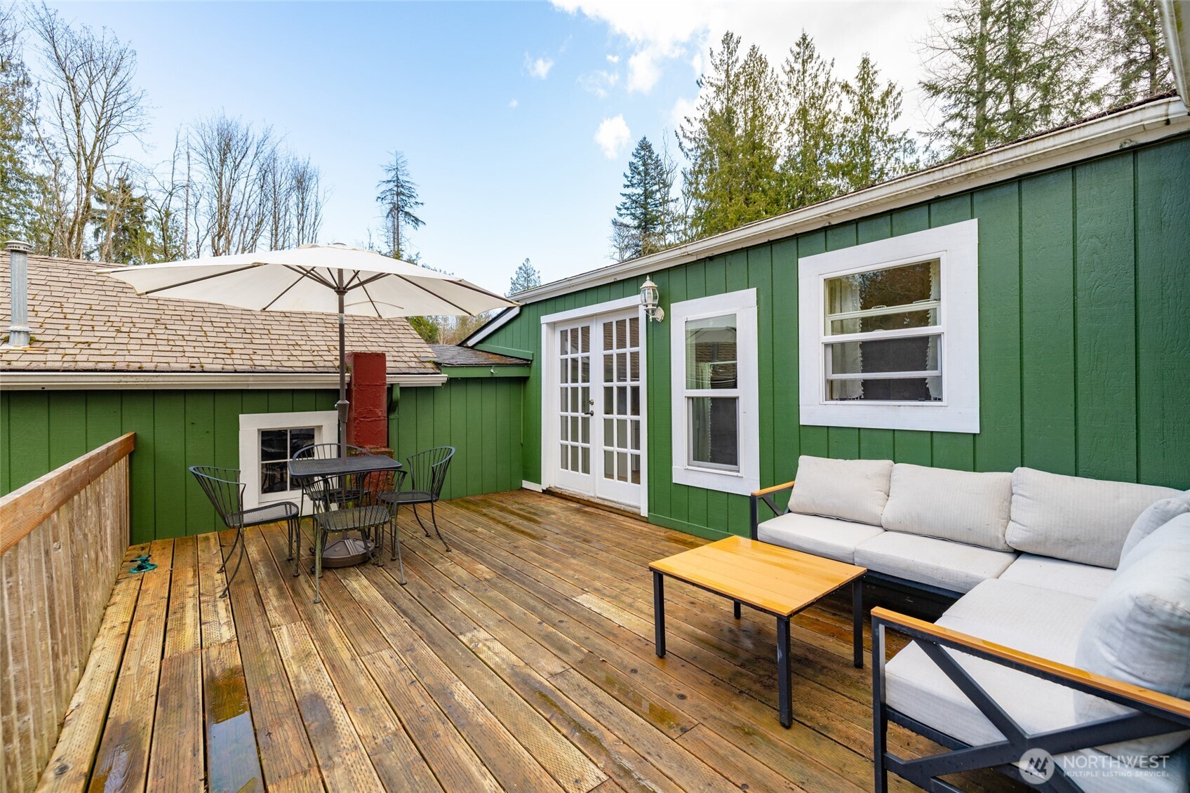 21260 Lake 16 Road Mount Vernon, WA 98274 - Photo 26 of 40 a view of a patio with couches and a table and chairs with wooden floor
