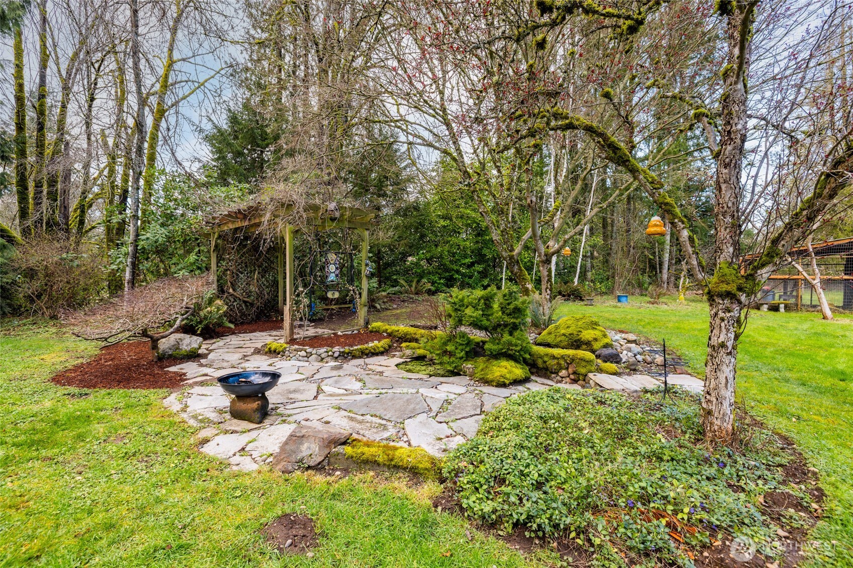 21260 Lake 16 Road Mount Vernon, WA 98274 - Photo 36 of 40 a view of swimming pool with lawn chairs and large trees