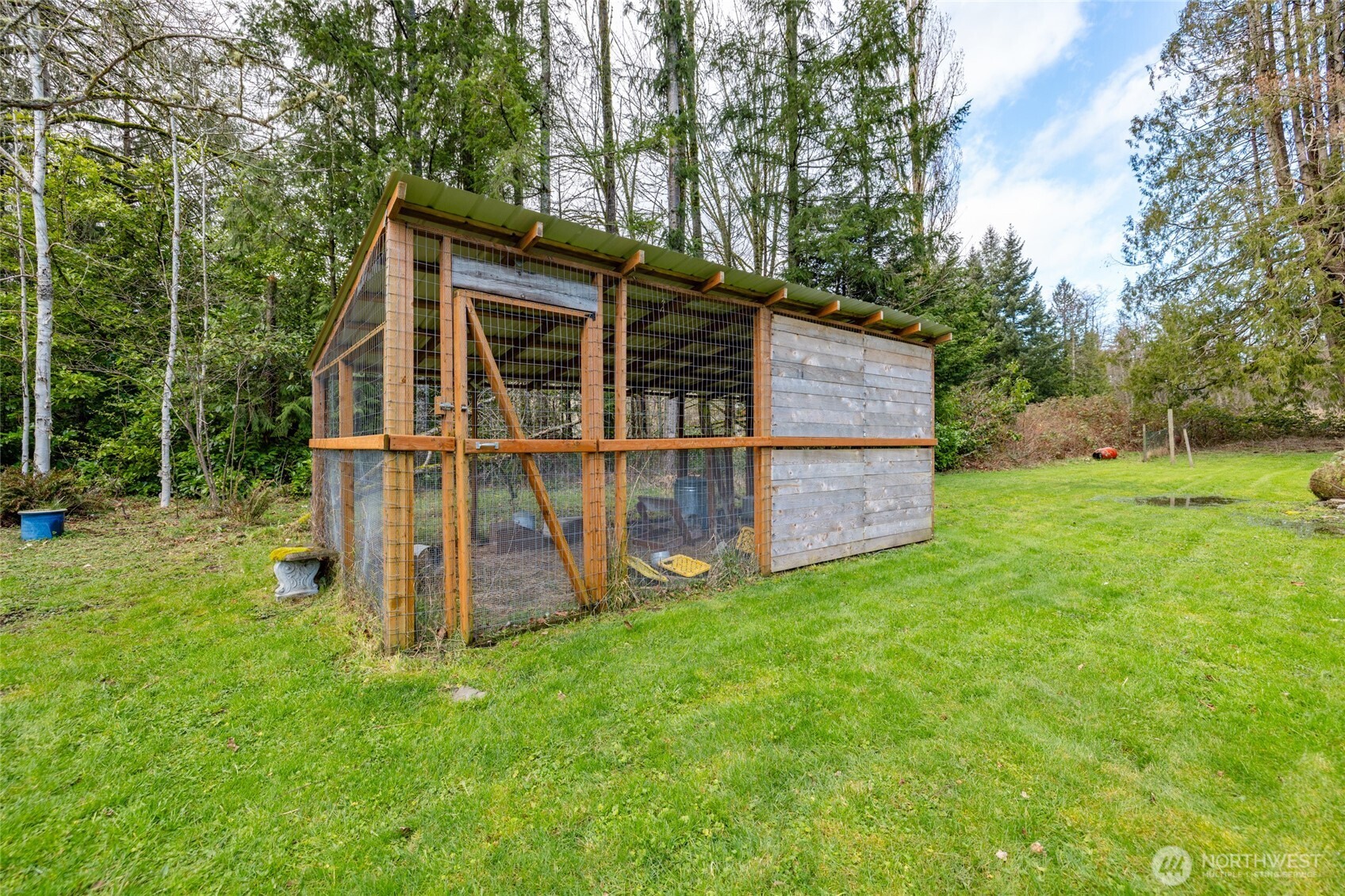21260 Lake 16 Road Mount Vernon, WA 98274 - Photo 37 of 40 a view of a backyard with wooden fence and large trees