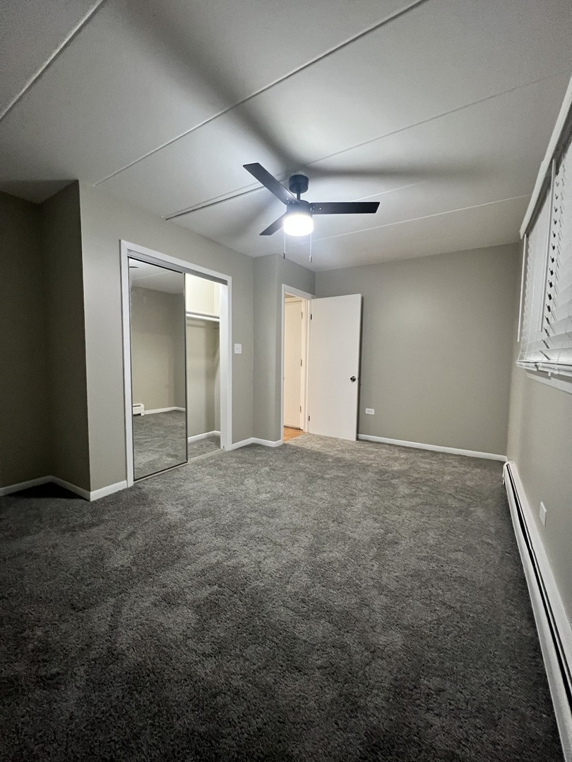 3330 Grove Avenue, Unit 1N Berwyn, IL 60402 - Photo 11 of 20 an empty room with closet and fan