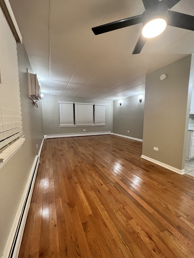 3330 Grove Avenue, Unit 1N Berwyn, IL 60402 - Photo 16 of 20 a view of an empty room with wooden floor