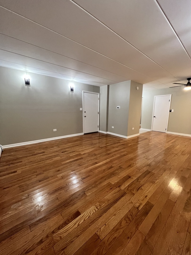 3330 Grove Avenue, Unit 1N Berwyn, IL 60402 - Photo 17 of 20 a view of an empty room with wooden floor