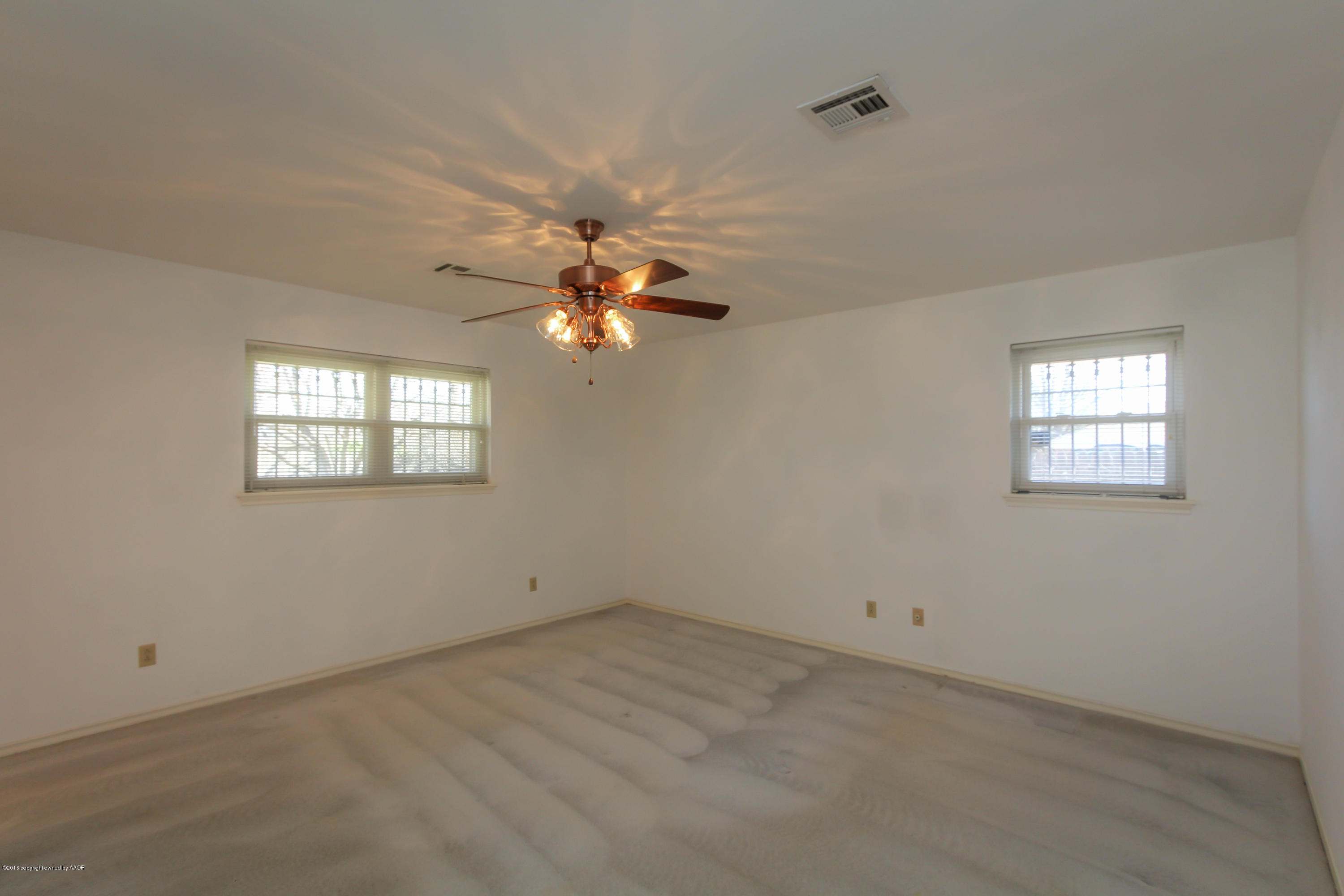 7012 Dreyfuss Road Amarillo, TX 79106 - Photo 3 of 39 an empty room with windows and fan
