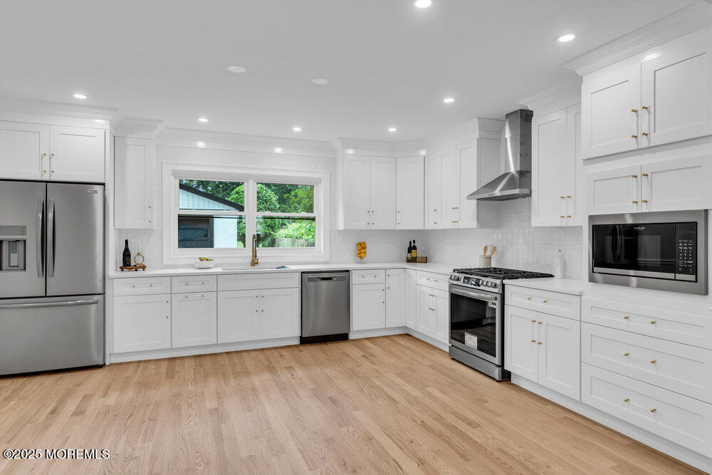 114 Harrison Avenue Red Bank, NJ 07701 - Photo 15 of 35 a large kitchen with cabinets a sink a window and stainless steel appliances