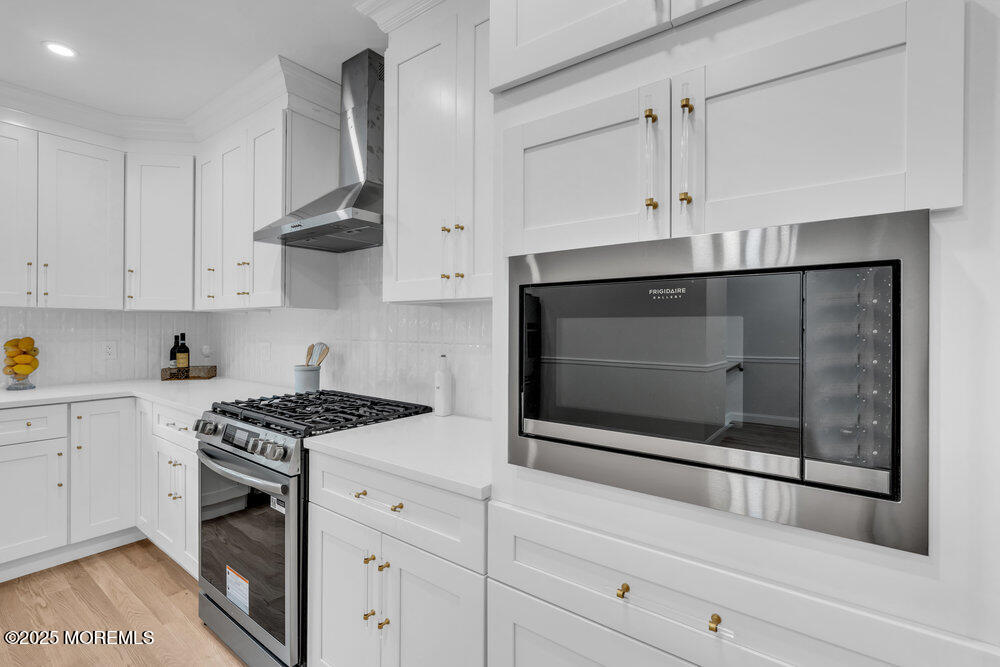 114 Harrison Avenue Red Bank, NJ 07701 - Photo 16 of 35 a kitchen with stainless steel appliances white cabinets and a stove top oven