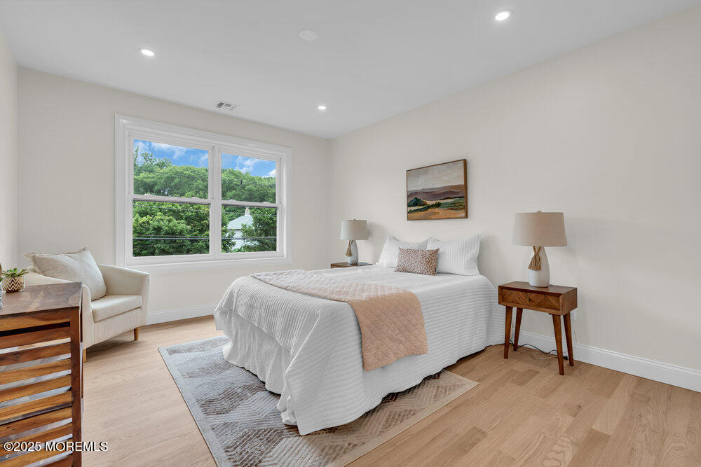 114 Harrison Avenue Red Bank, NJ 07701 - Photo 19 of 35 a bed room with a bed and a chair
