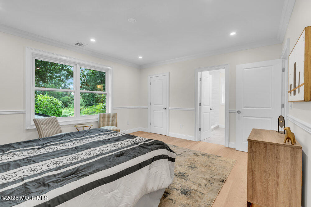 114 Harrison Avenue Red Bank, NJ 07701 - Photo 24 of 35 a spacious bedroom with a bed and a large window