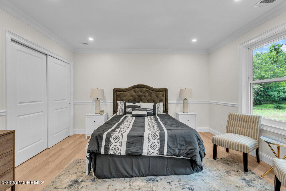 114 Harrison Avenue Red Bank, NJ 07701 - Photo 25 of 35 a bedroom with a bed and a chair