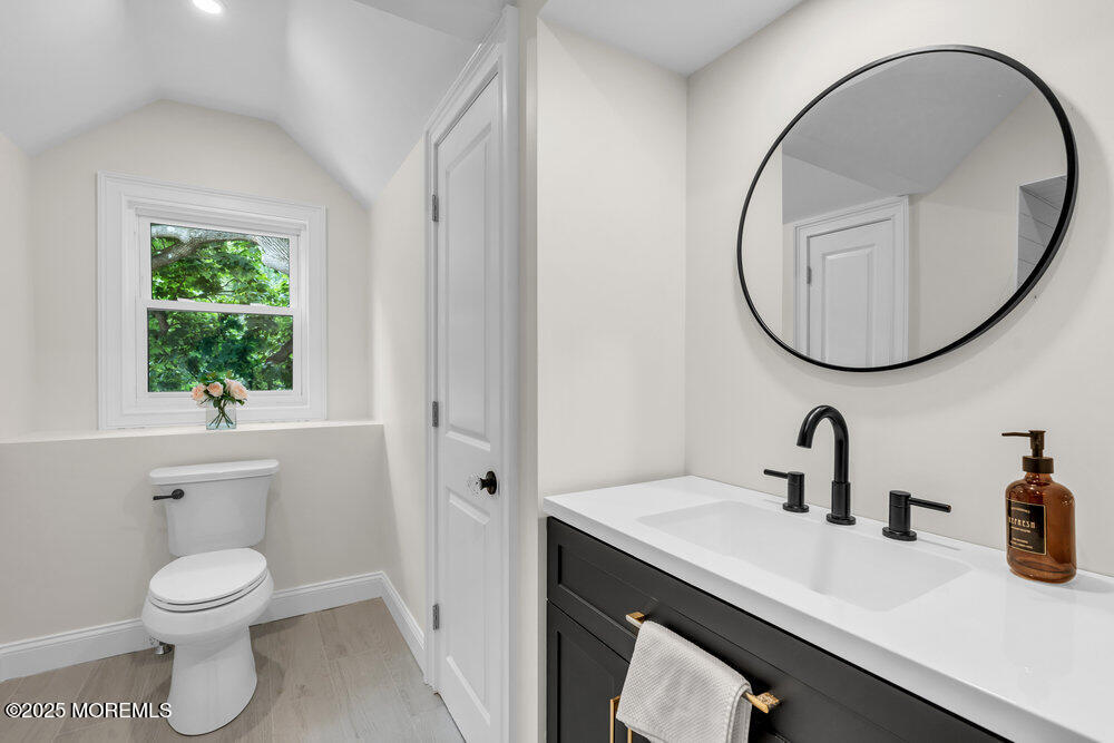 114 Harrison Avenue Red Bank, NJ 07701 - Photo 29 of 35 a bathroom with a toilet a sink and a mirror