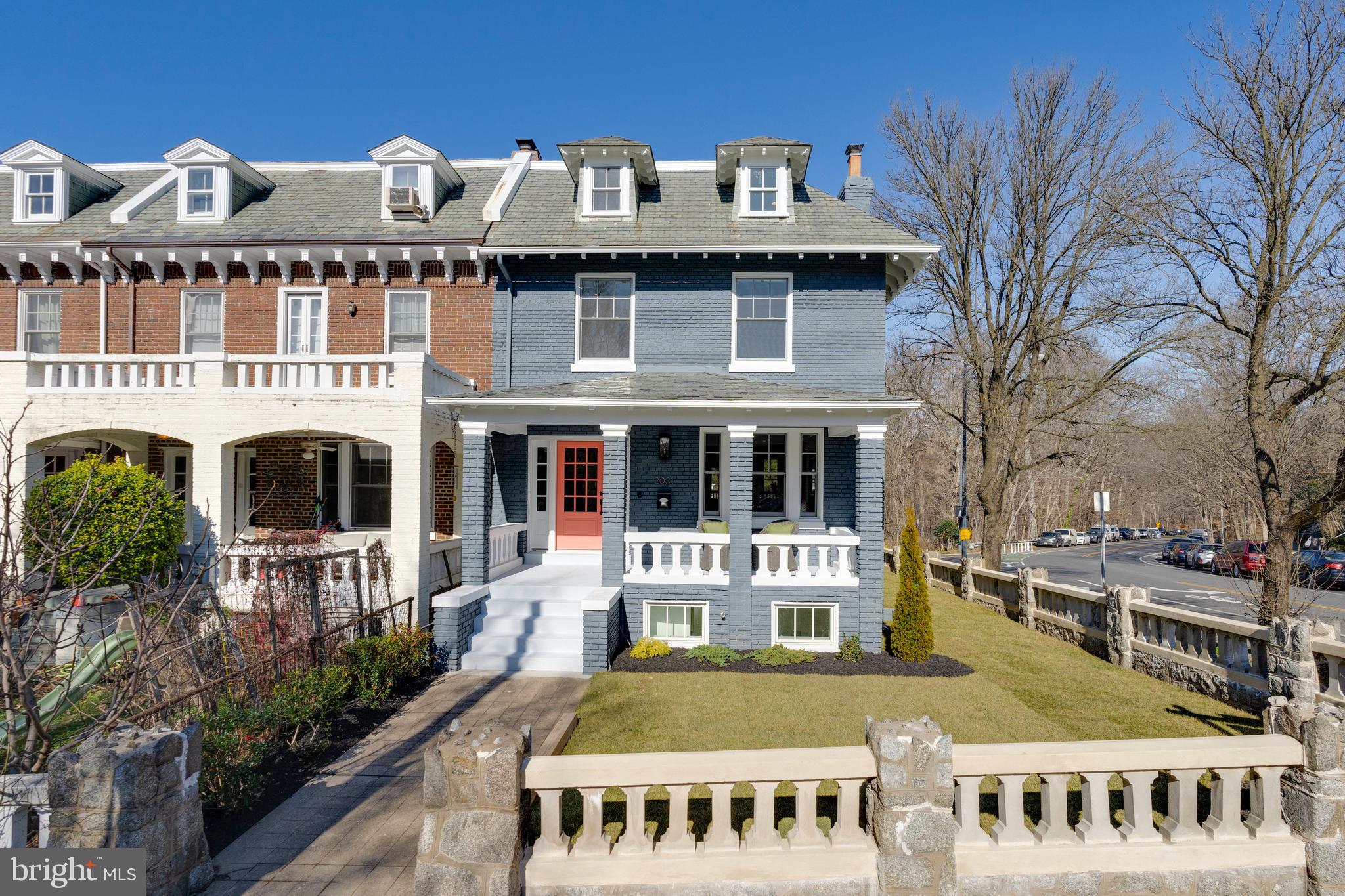 a front view of a building with a garden