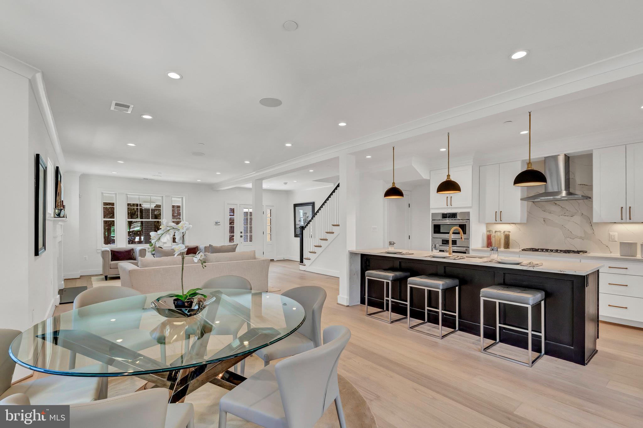 2001 Klingle Road Northwest Washington, DC 20010 - Photo 16 of 50 a living room with stainless steel appliances kitchen island granite countertop a dining table chairs and couches with wooden floor
