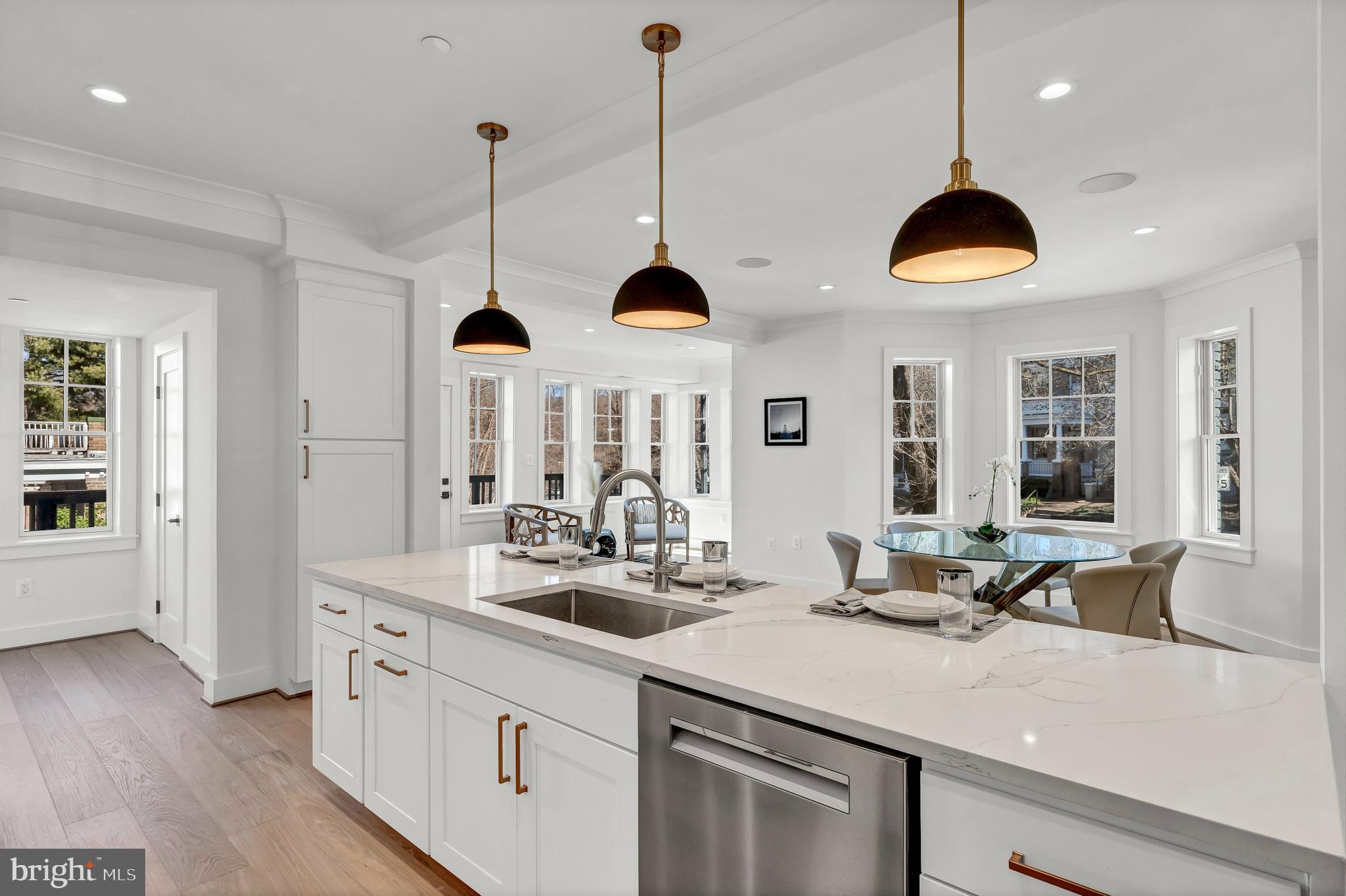 2001 Klingle Road Northwest Washington, DC 20010 - Photo 17 of 50 a kitchen with stainless steel appliances granite countertop a stove a sink and a wooden floors