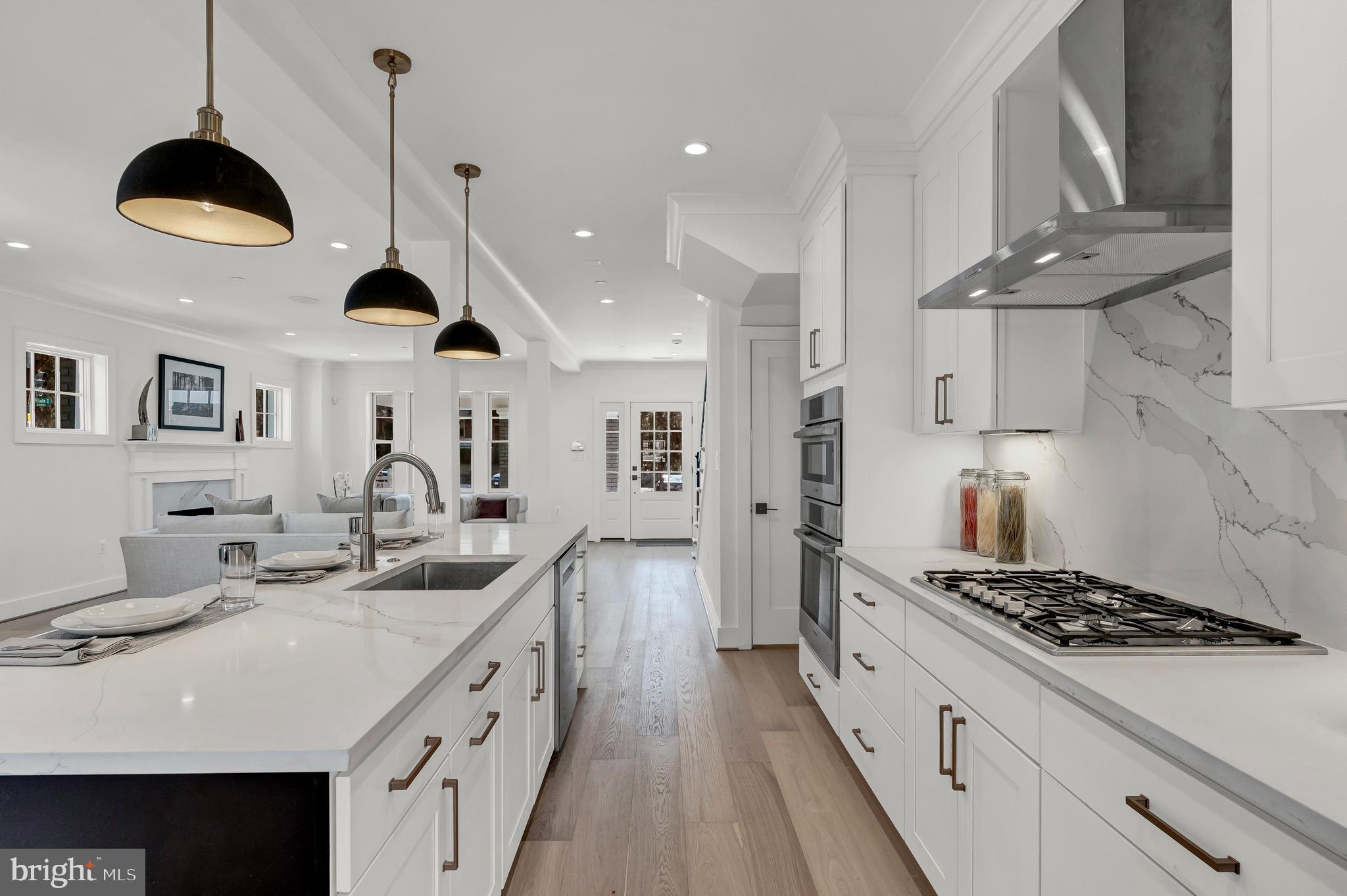 2001 Klingle Road Northwest Washington, DC 20010 - Photo 19 of 50 a kitchen with stainless steel appliances a sink a stove and a wooden floors