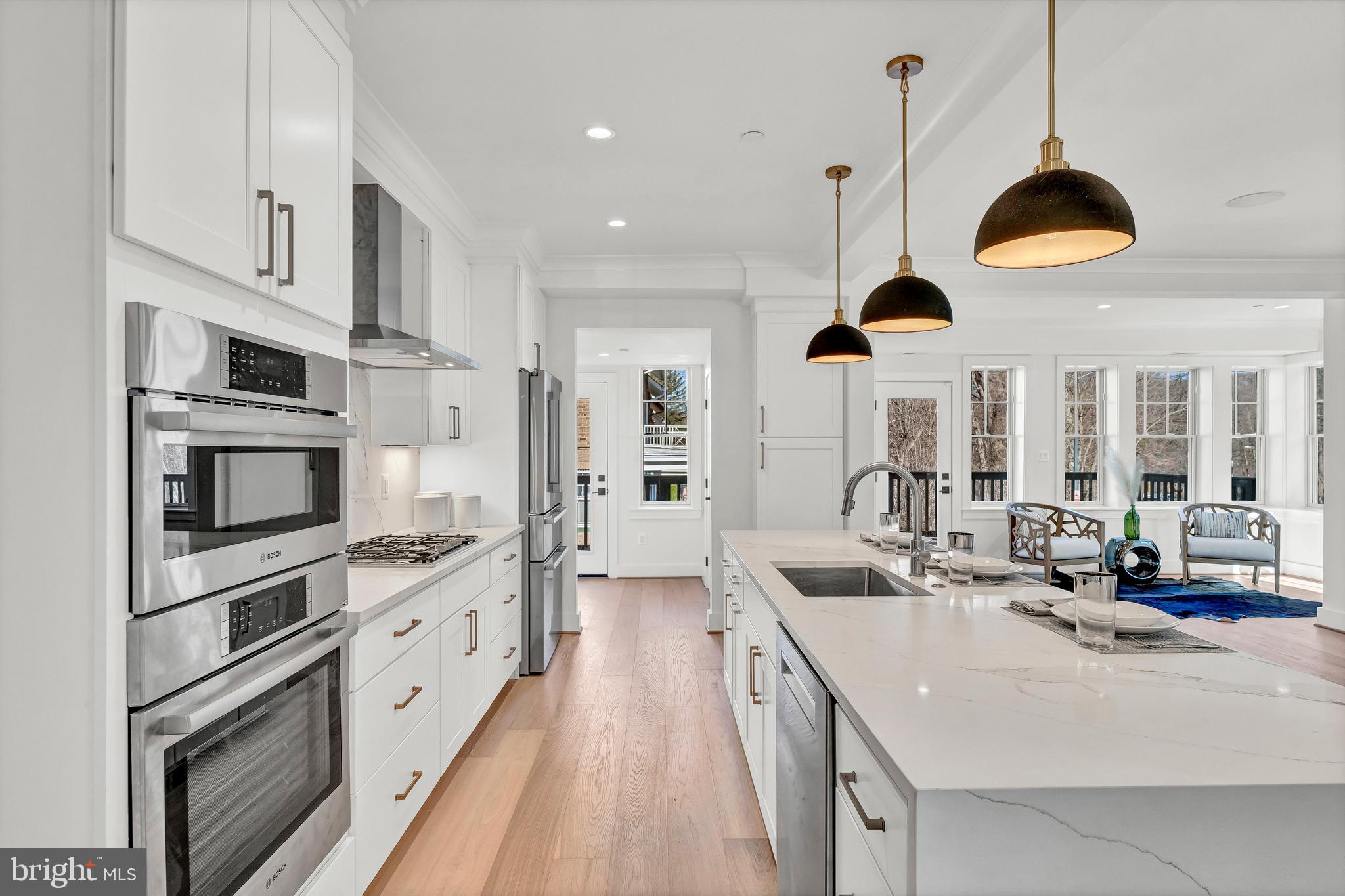 2001 Klingle Road Northwest Washington, DC 20010 - Photo 21 of 50 a kitchen with kitchen island granite countertop a sink a counter space appliances and cabinets