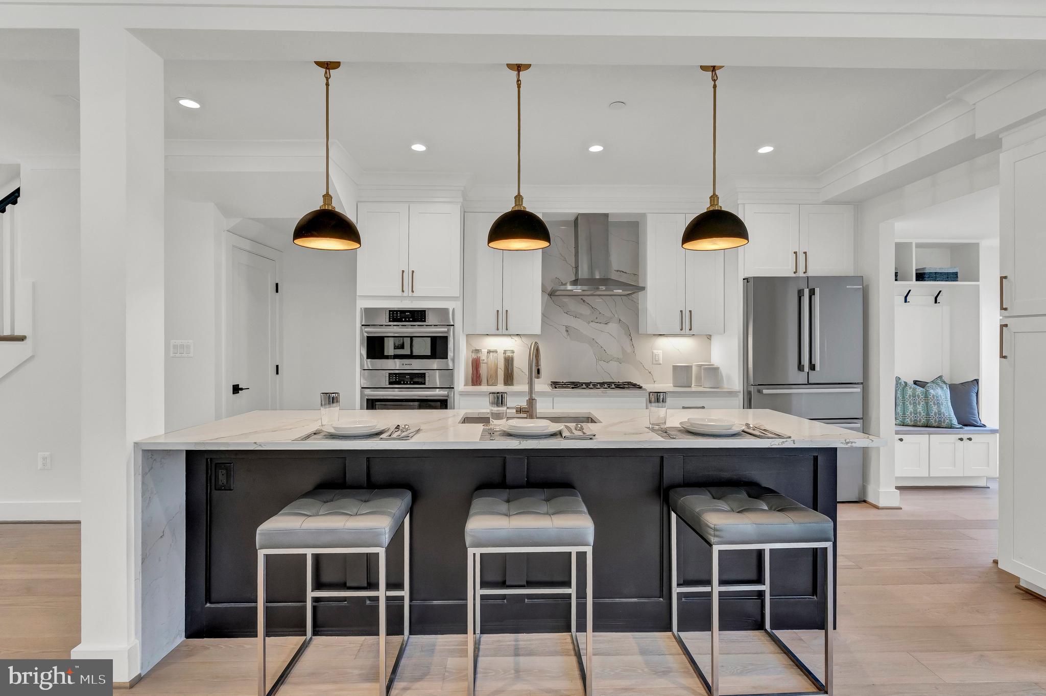 2001 Klingle Road Northwest Washington, DC 20010 - Photo 22 of 50 a kitchen with stainless steel appliances kitchen island a table and chairs in it