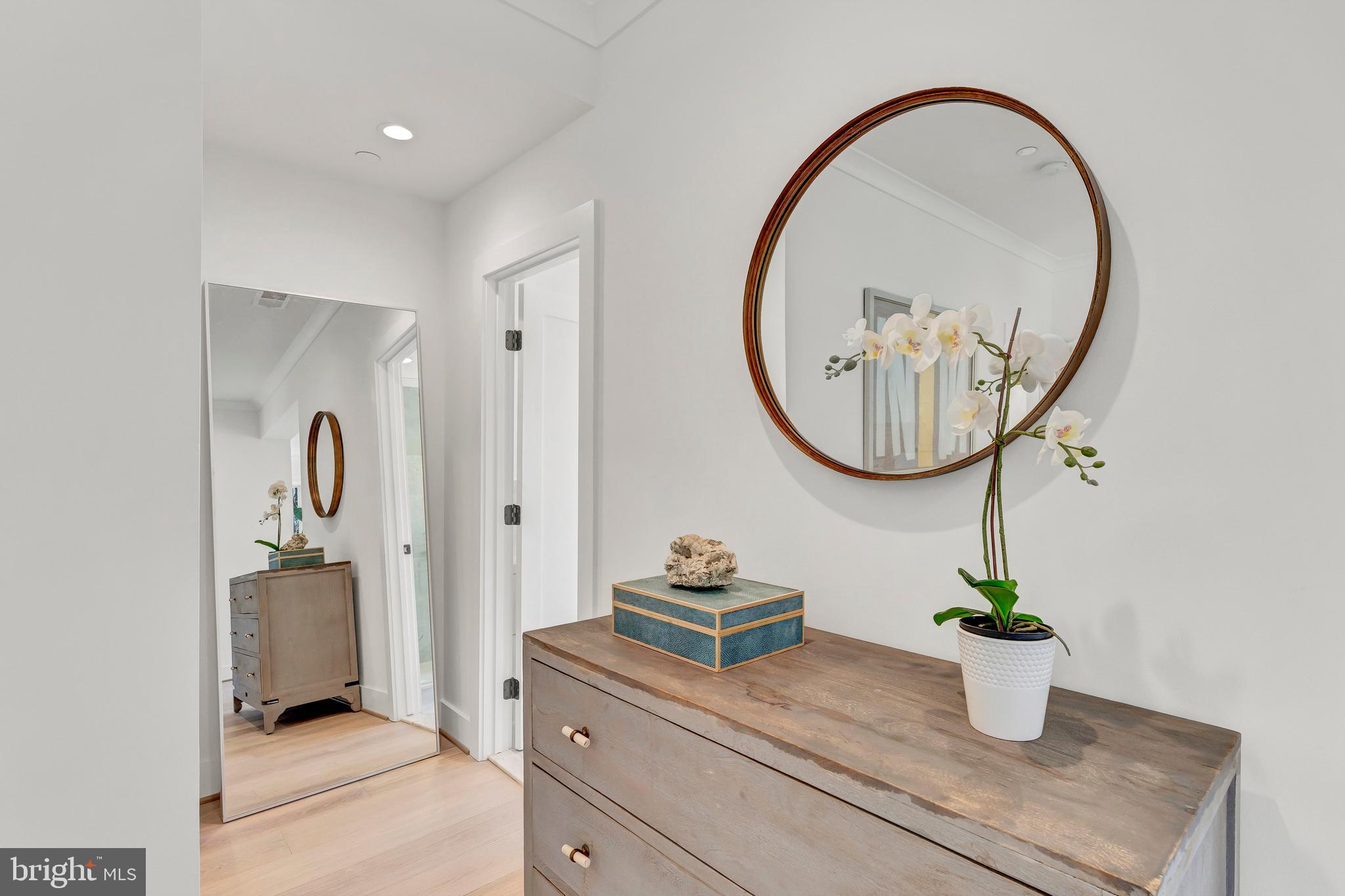 2001 Klingle Road Northwest Washington, DC 20010 - Photo 31 of 50 a bathroom with a sink a mirror and a potted plant