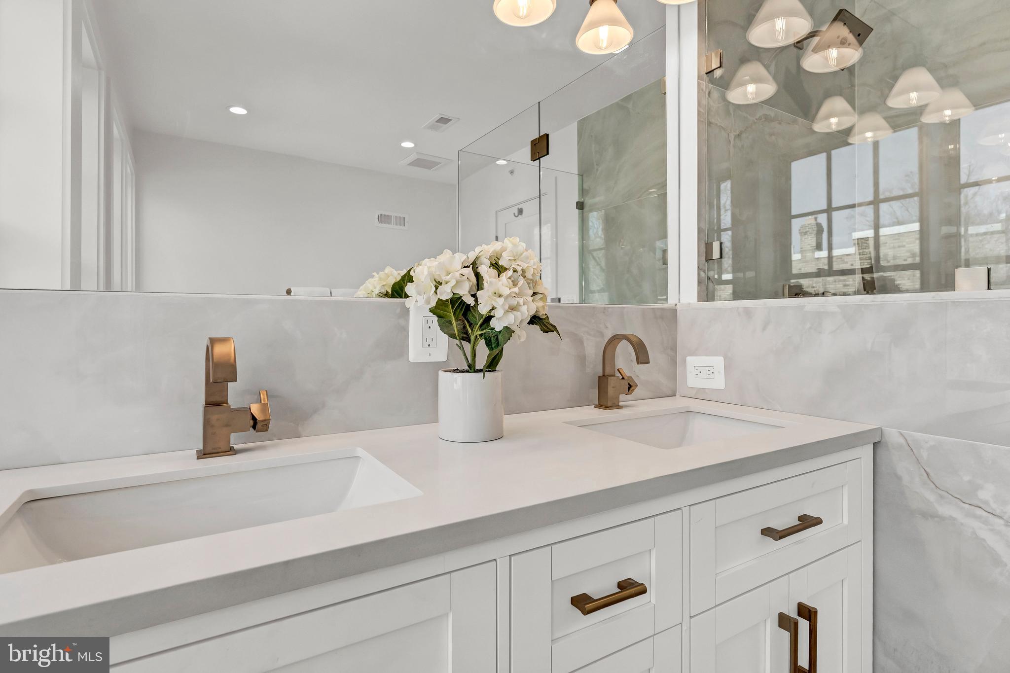 2001 Klingle Road Northwest Washington, DC 20010 - Photo 37 of 50 a bathroom with a sink a vanity and a mirror