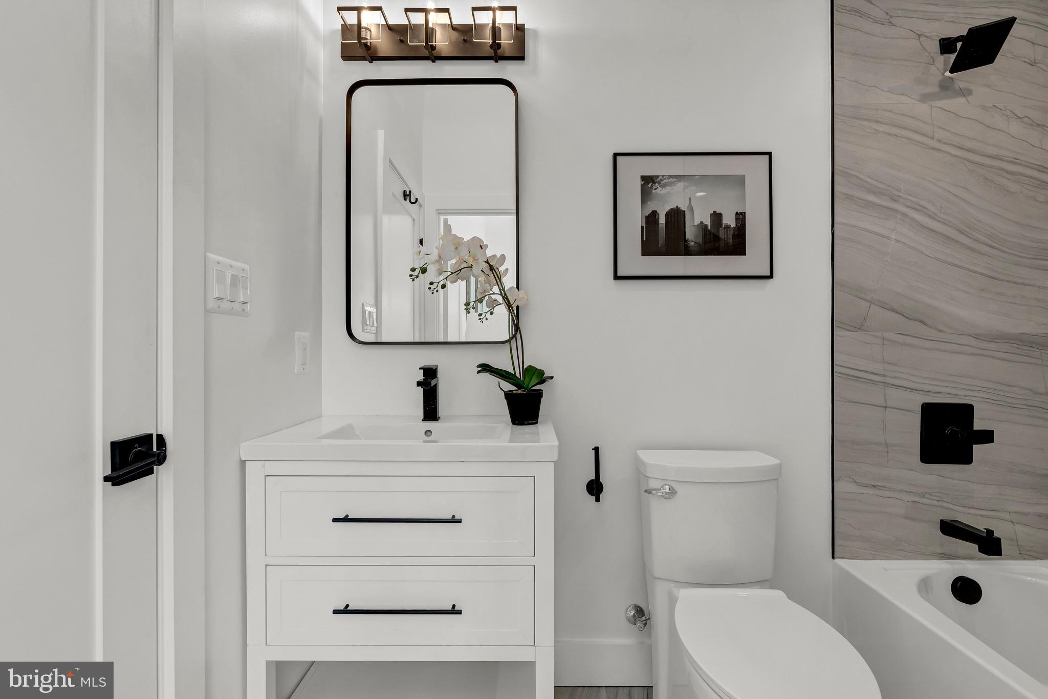 2001 Klingle Road Northwest Washington, DC 20010 - Photo 39 of 50 a bathroom with a sink vanity mirror and toilet