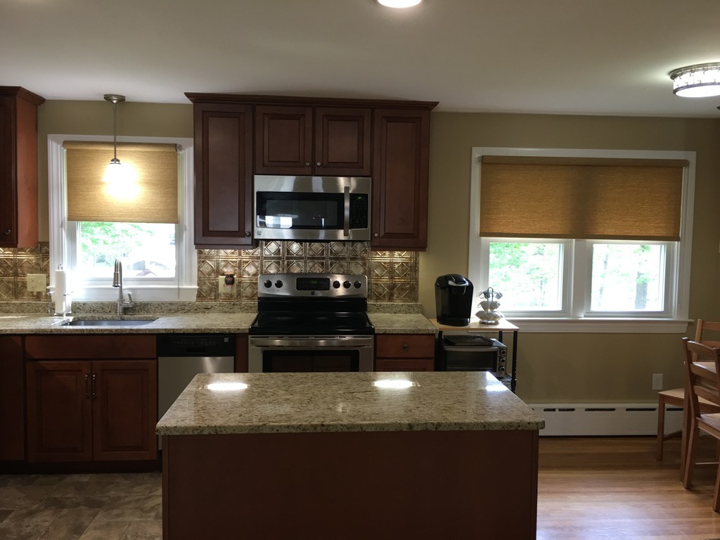 66 Lancaster Road Clinton, MA 01510 - Photo 5 of 19 a kitchen with kitchen island granite countertop a sink appliances and cabinets