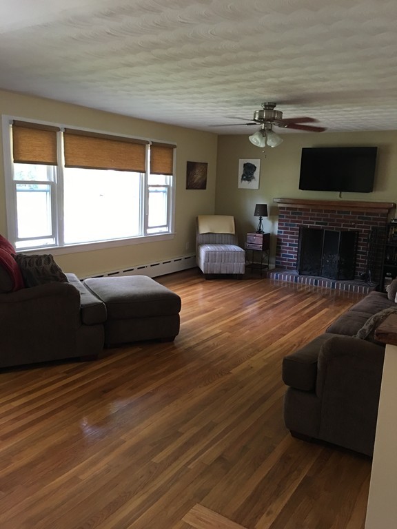 66 Lancaster Road Clinton, MA 01510 - Photo 8 of 19 a living room with furniture flat screen tv and a fireplace