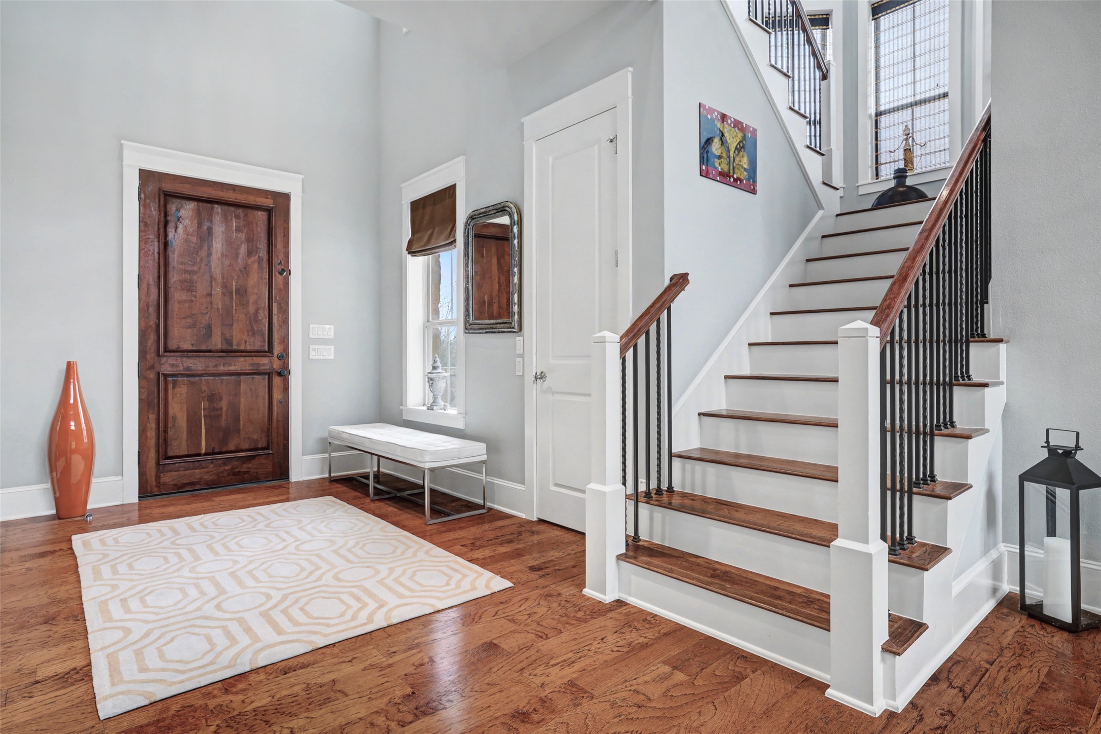 816 Stonewall Ridge Lane Austin, TX 78746 - Photo 28 of 32 Enter into a bright, inviting space featuring gleaming hardwood floors and a grand staircase.