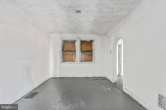 an empty room with a windows