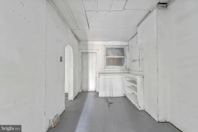 a view of a kitchen with white cabinets