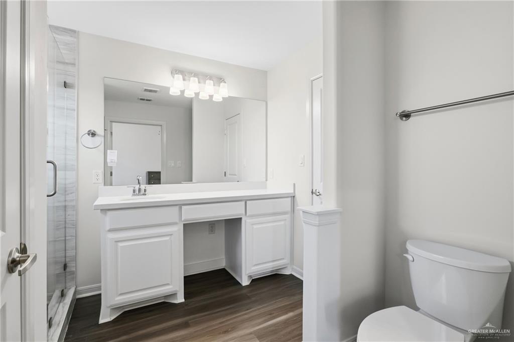 14221 Chalk Rdg Drive McAllen, TX 78504 - Photo 13 of 17 a bathroom with a sink toilet a mirror and shower