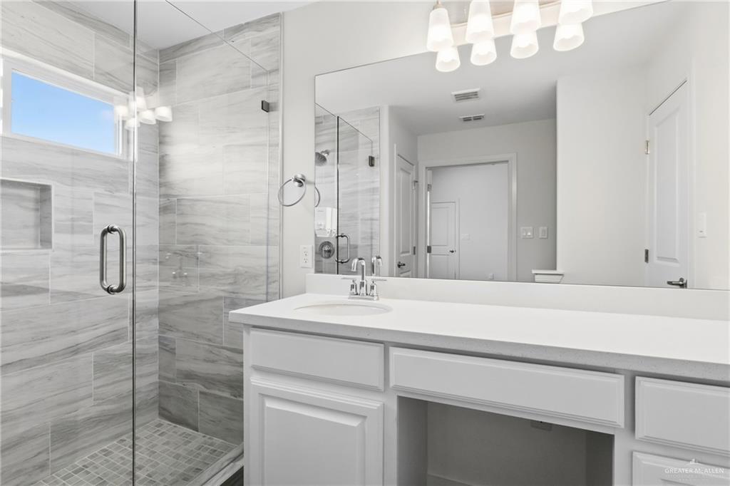 14221 Chalk Rdg Drive McAllen, TX 78504 - Photo 14 of 17 a bathroom with a sink vanity granite shower and a mirror