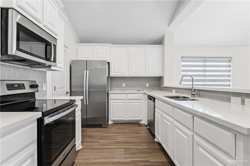 14221 Chalk Rdg Drive McAllen, TX 78504 - Photo 5 of 17 a kitchen with stainless steel appliances granite countertop a sink stove microwave and refrigerator