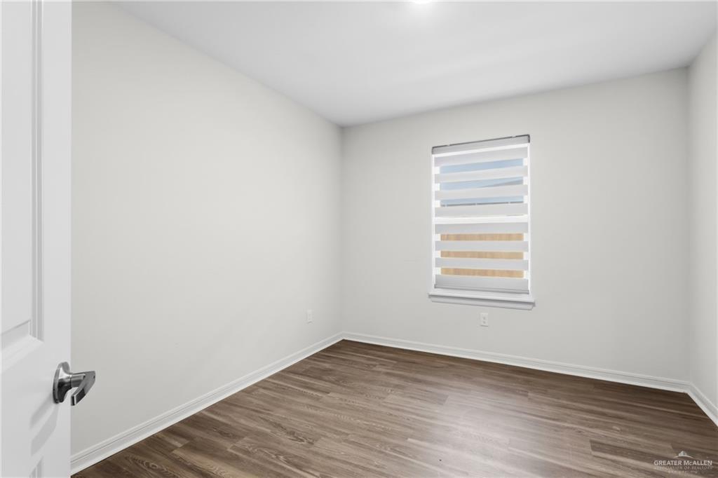 14221 Chalk Rdg Drive McAllen, TX 78504 - Photo 8 of 17 a view of empty room with wooden floor and fan