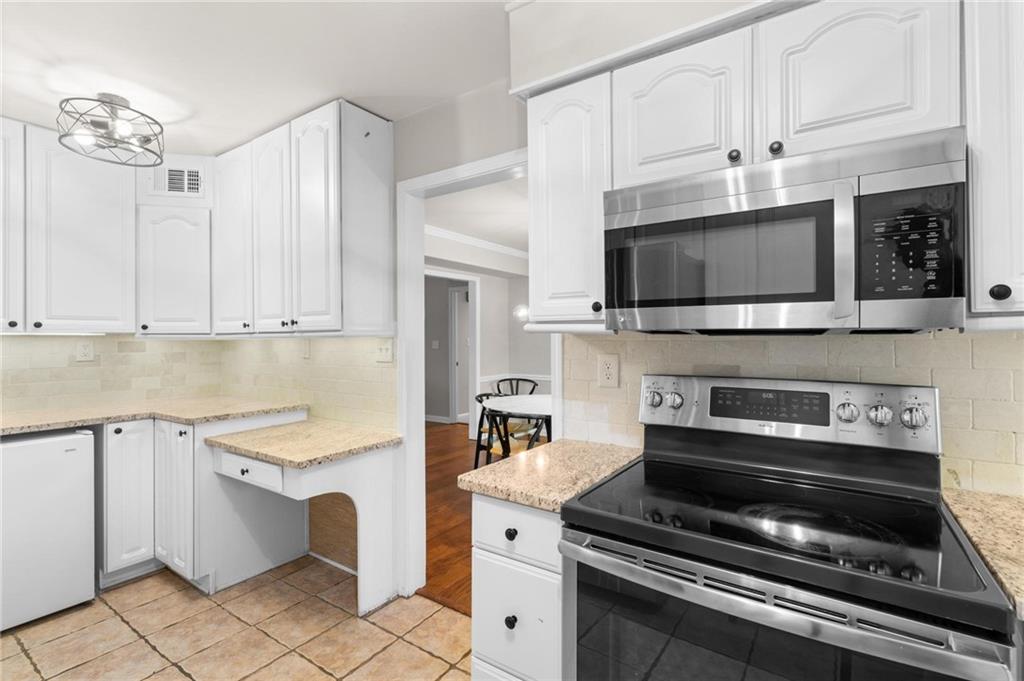 34 Chaumont Square Northwest Atlanta, GA 30327 - Photo 11 of 42 a kitchen with cabinets stainless steel appliances and a counter space