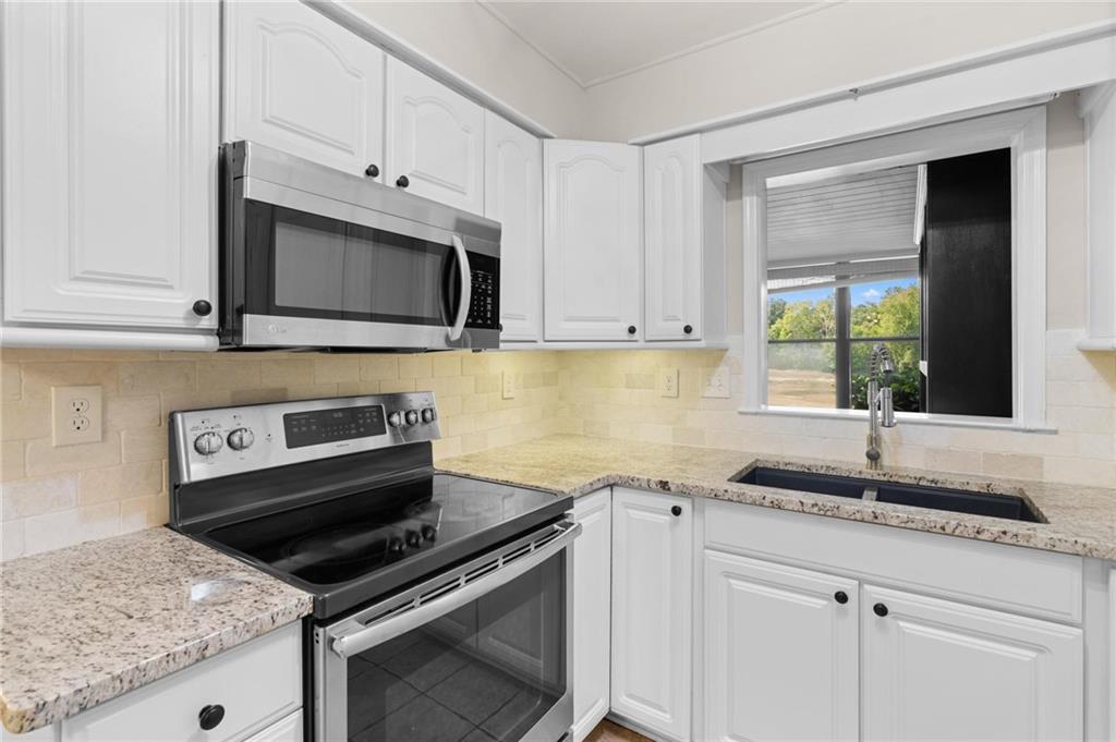 34 Chaumont Square Northwest Atlanta, GA 30327 - Photo 12 of 42 a kitchen with granite countertop white cabinets and appliances