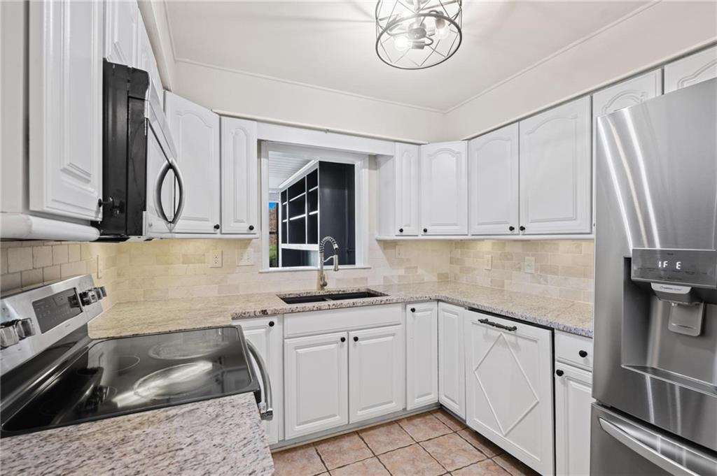 34 Chaumont Square Northwest Atlanta, GA 30327 - Photo 13 of 42 a kitchen with white cabinets and sink