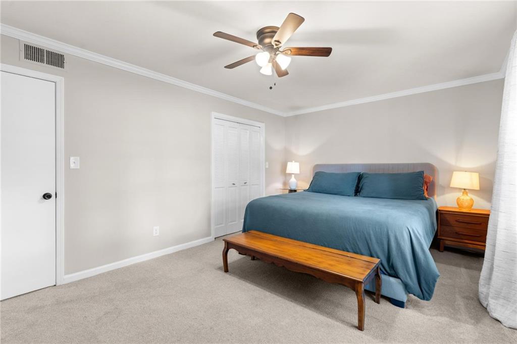 34 Chaumont Square Northwest Atlanta, GA 30327 - Photo 21 of 42 a bedroom with a bed and a ceiling fan