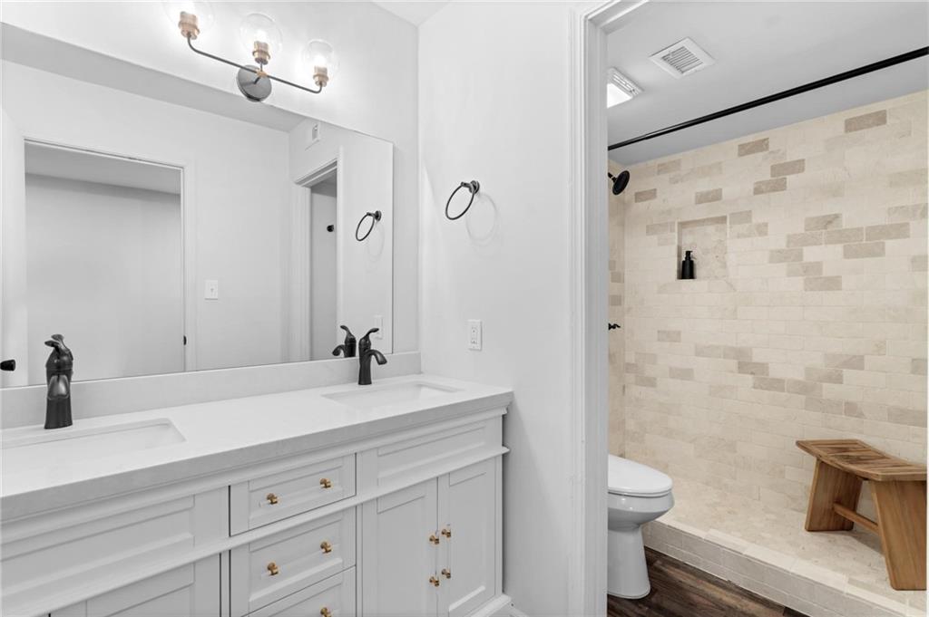 34 Chaumont Square Northwest Atlanta, GA 30327 - Photo 27 of 42 a bathroom with a sink a toilet and a large mirror
